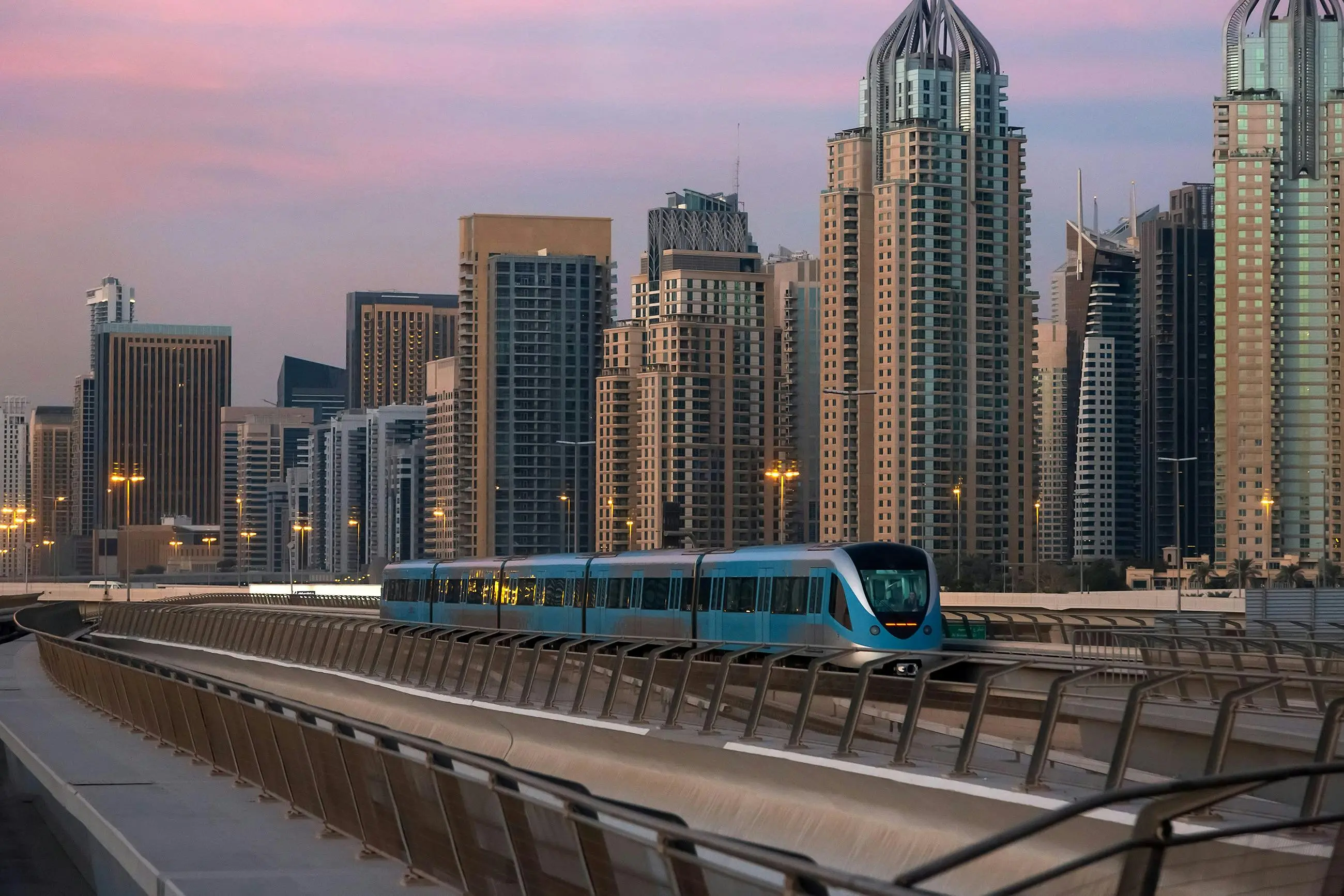 Dubai Metro At Sunset With Iconic Skyline