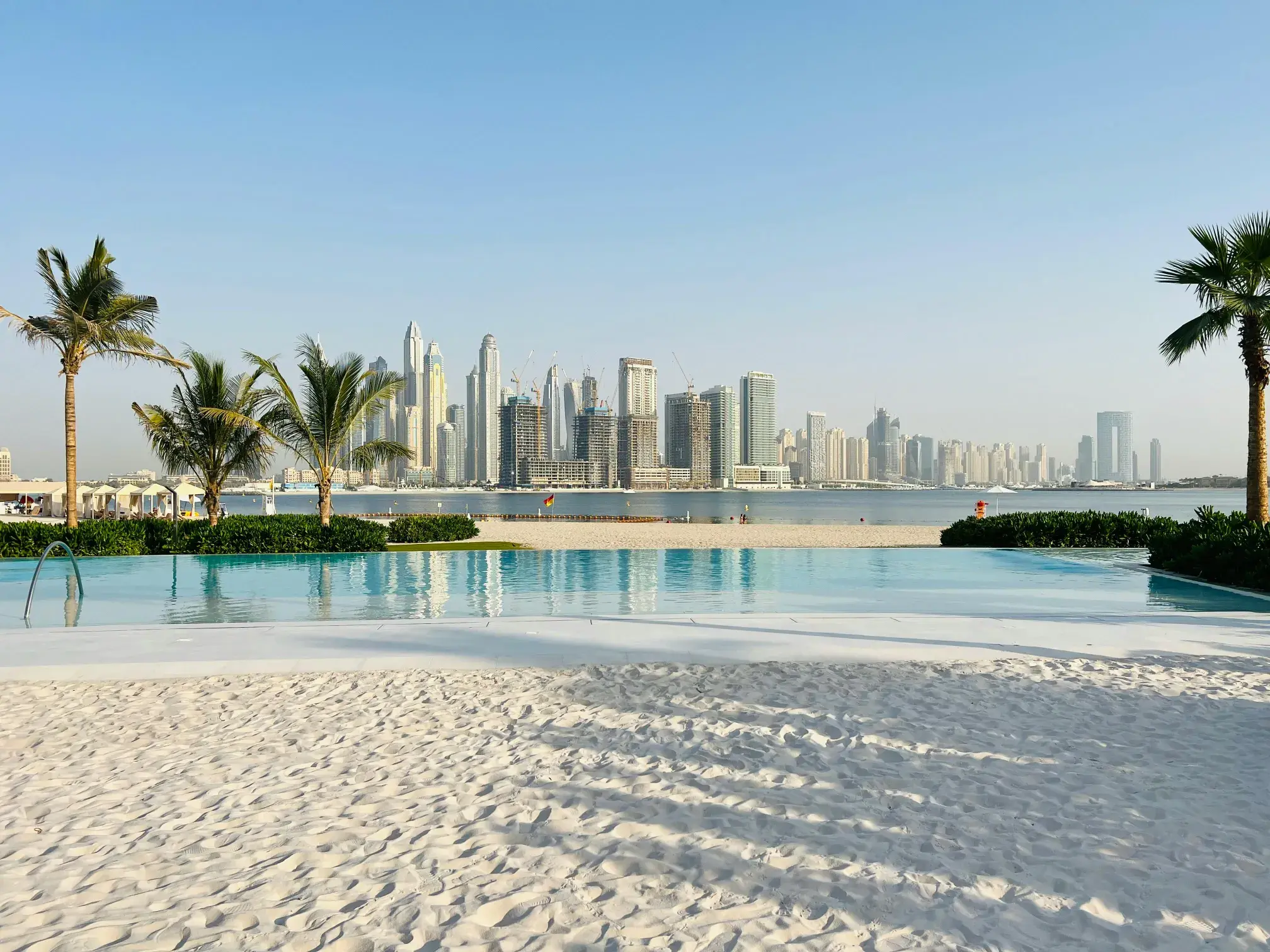 Dubai Skyline View From A Beachfront Pool